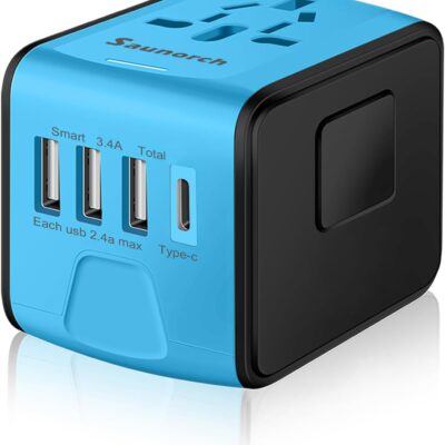 Compact blue and black universal travel adapter with multiple USB ports, including three standard USB slots, one USB-C port, and a universal plug socket on top. Designed for international charging convenience with labeled outputs and a sleek cube-shaped design.